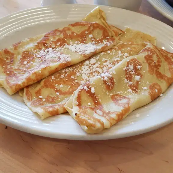 Crepes filled and topped with powdered sugar