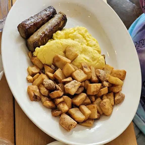 Scrambled eggs with sausage and home fries breakfast plate
