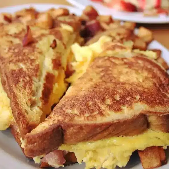 Stuffed French toast with eggs and breakfast filling