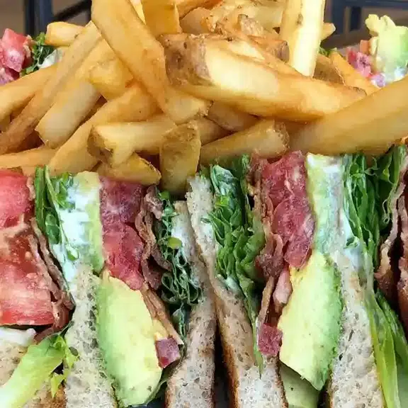 Club sandwich with fries lettuce tomato and bacon