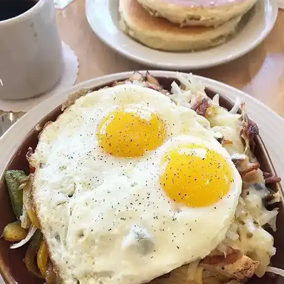 Biscuits and gravy topped with creamy sauce